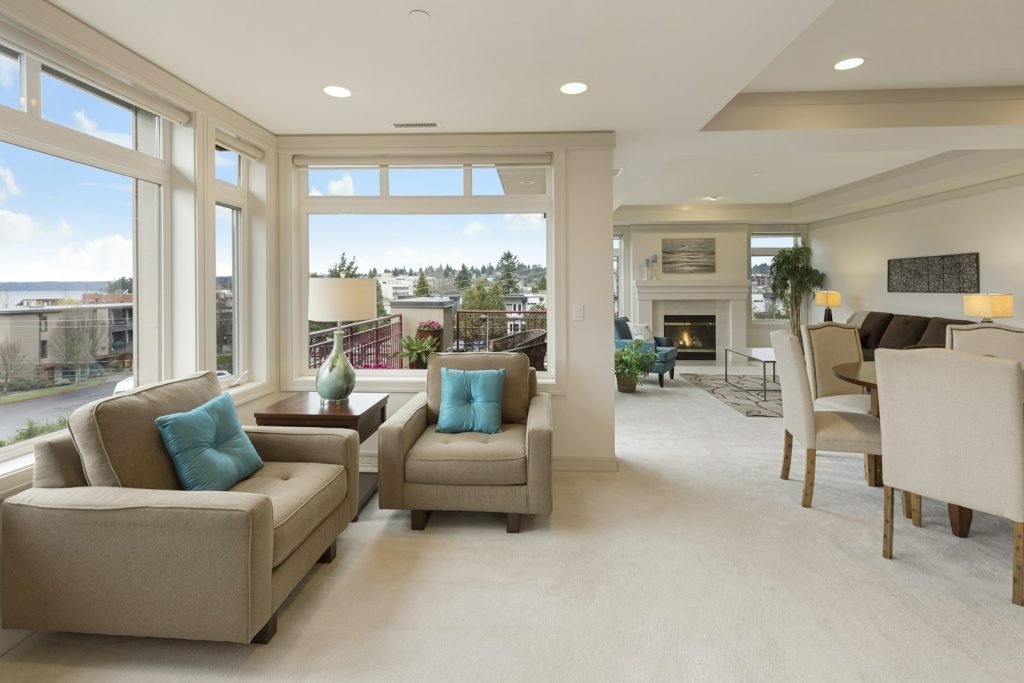 Bright living area with armchairs and large windows