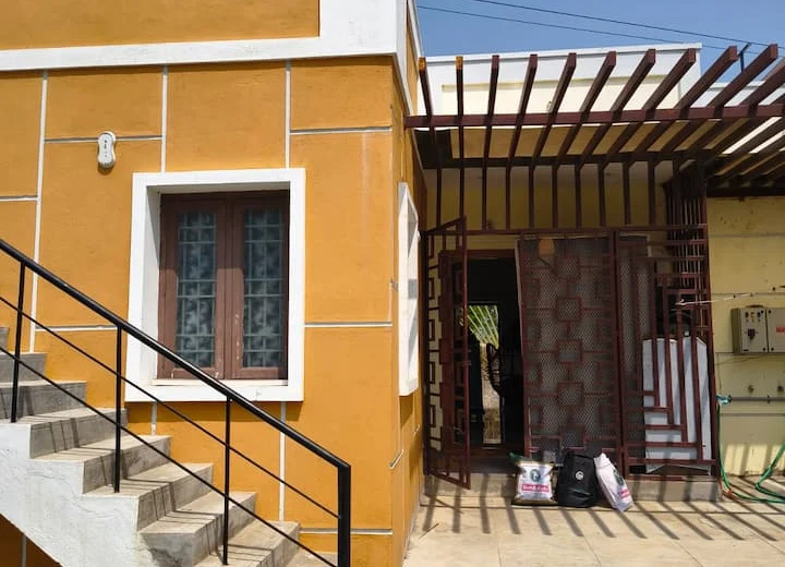 Front of Meena’s Guest Home in Pathukannu, Puducherry, with steps and the entrance