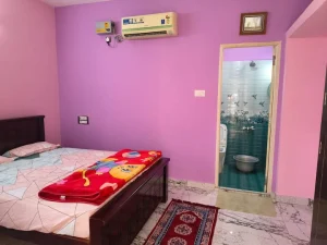 Meena’s Guest Home, Pathukannu – Bedroom with air conditioning and bathroom door