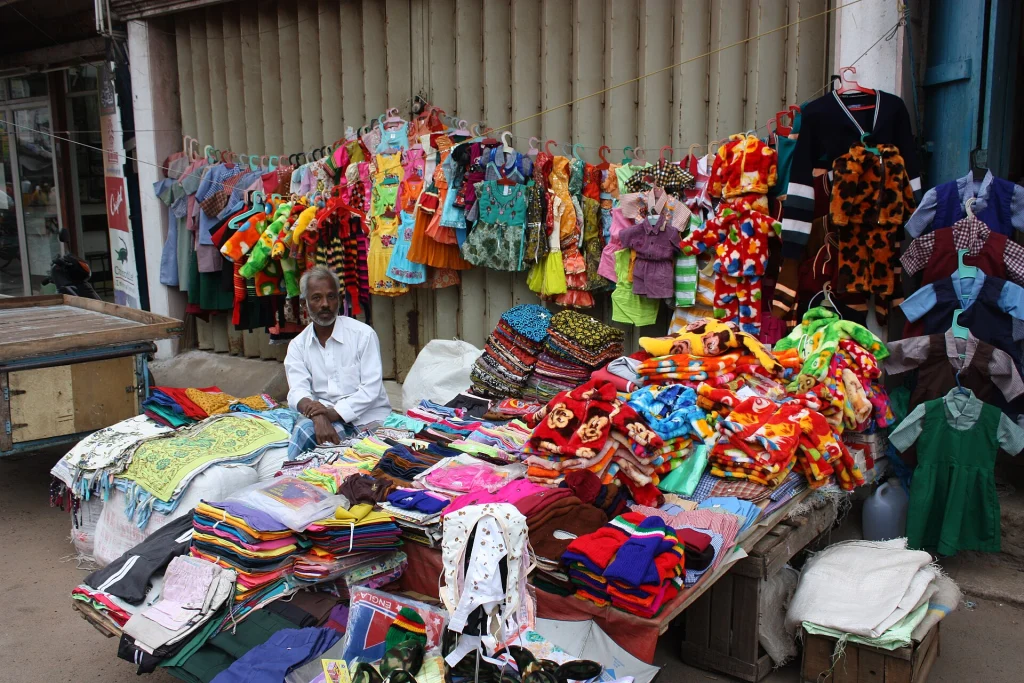 Street stall selling colourful children’s clothes in the Trichy old-city market